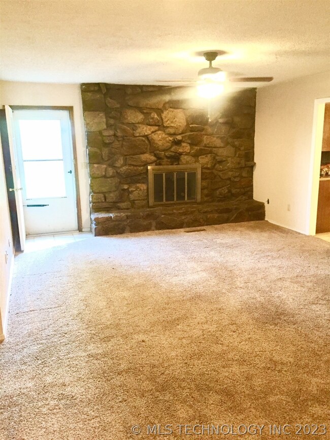 Living Room with Fireplace, door is access to back