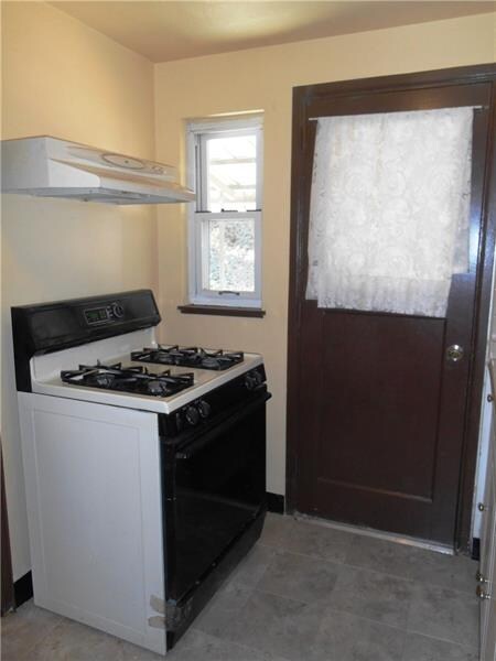 Gas stove conveys with sale.  This door leads to t