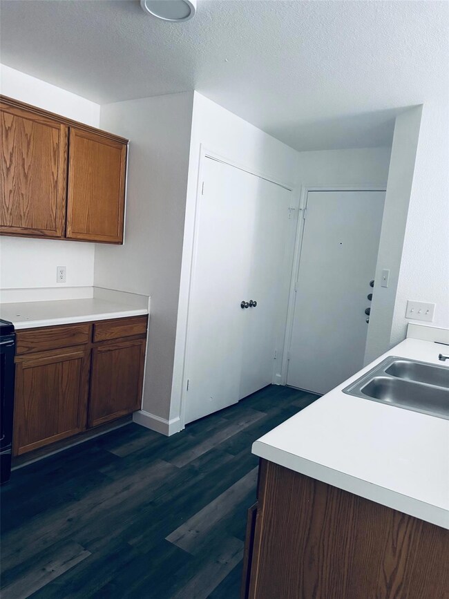 Kitchen featuring a sink, light countertops, brow