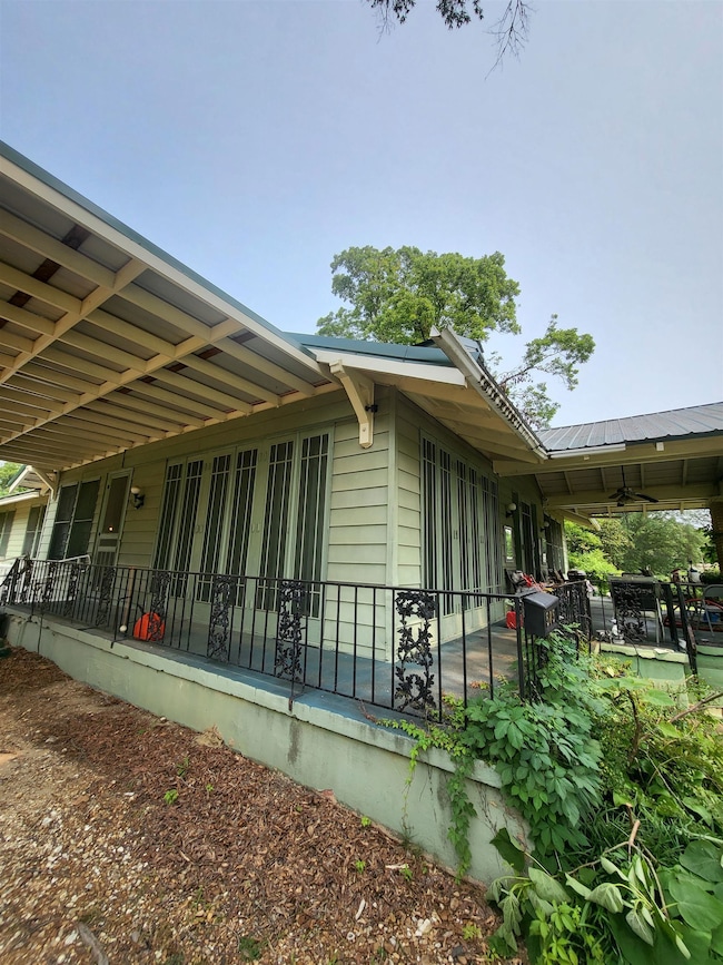 View of side of home with ceiling fan