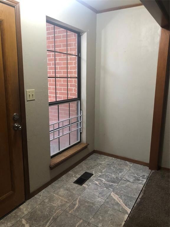Entry way has tiled mudroom for shoes or nice spot for plants