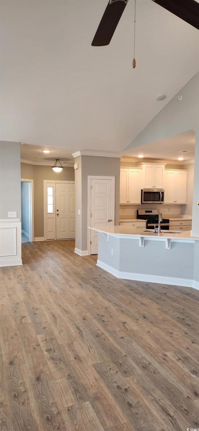 Unfurnished living room featuring lofted ceiling, 