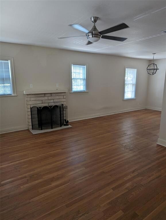 Unfurnished living room featuring dark wood-type 