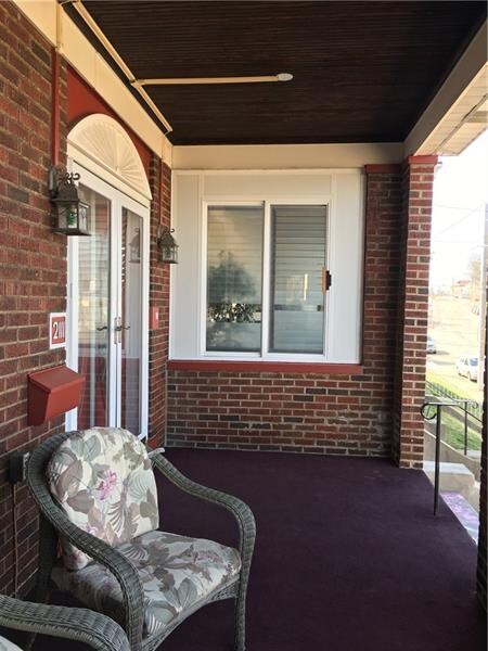 Spacious covered and carpeted front porch.