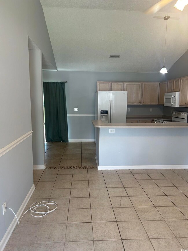 Kitchen with light tile patterned flooring, lofted
