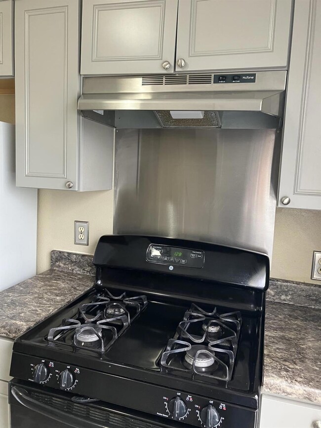 Room details featuring dark stone counters, black