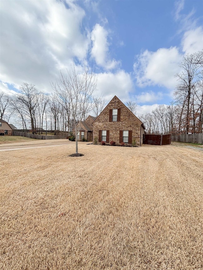 View of front of house with fence and a front lawn