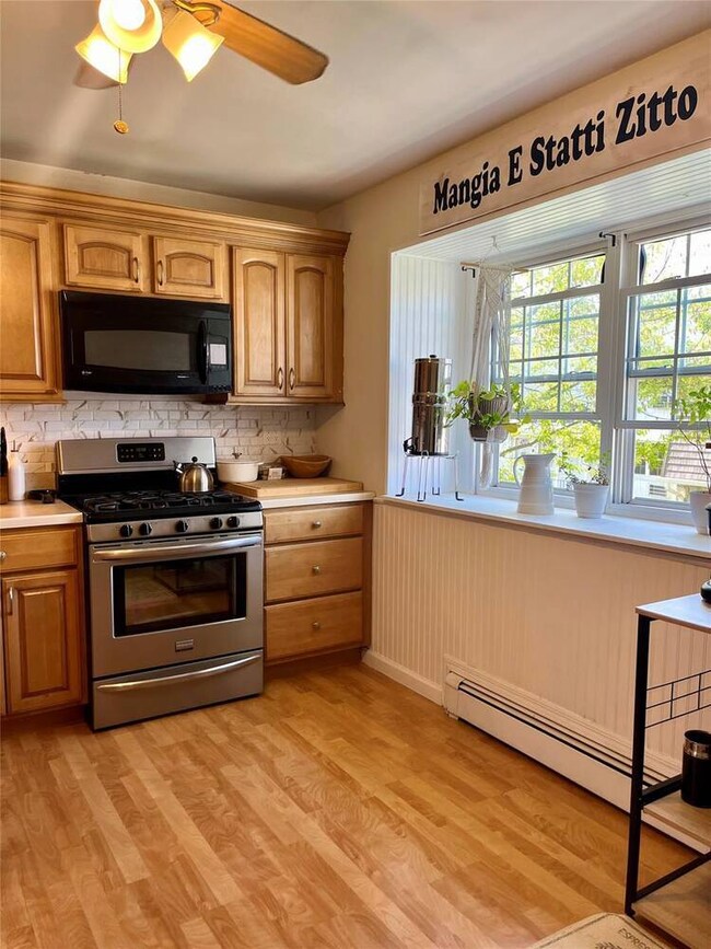 Kitchen featuring stainless steel gas stove, black