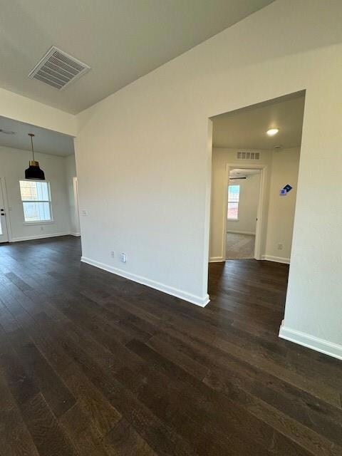 Spare room with dark wood-type flooring