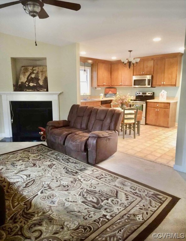 Living room featuring ceiling fan with notable cha