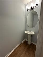 Bathroom featuring baseboards and wood finished floors