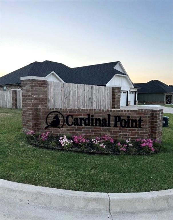 Community / neighborhood sign with a yard