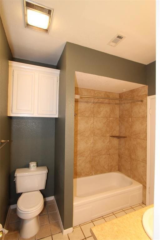 Full bath featuring toilet, tile patterned floori