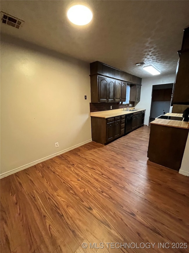 Kitchen with light countertops, wood finished floo