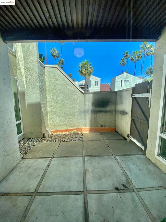 View of patio featuring a gate