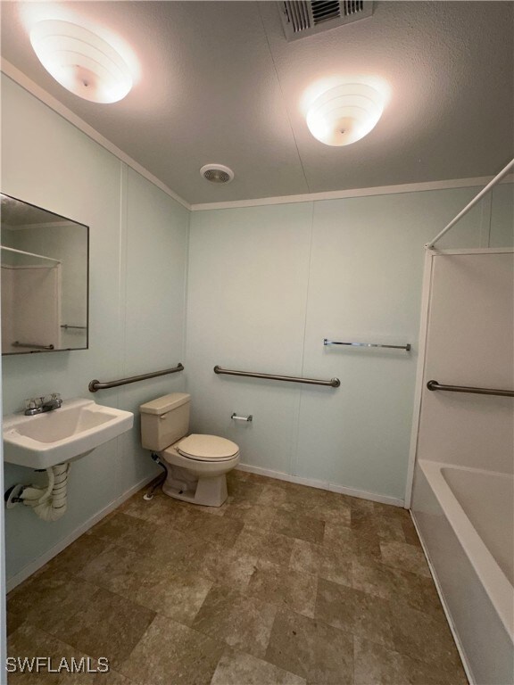 Full bathroom with sink, bathing tub / shower combination, toilet, and tile patterned floors