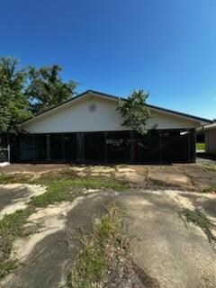 Ranch-style home with asphalt driveway and a carport