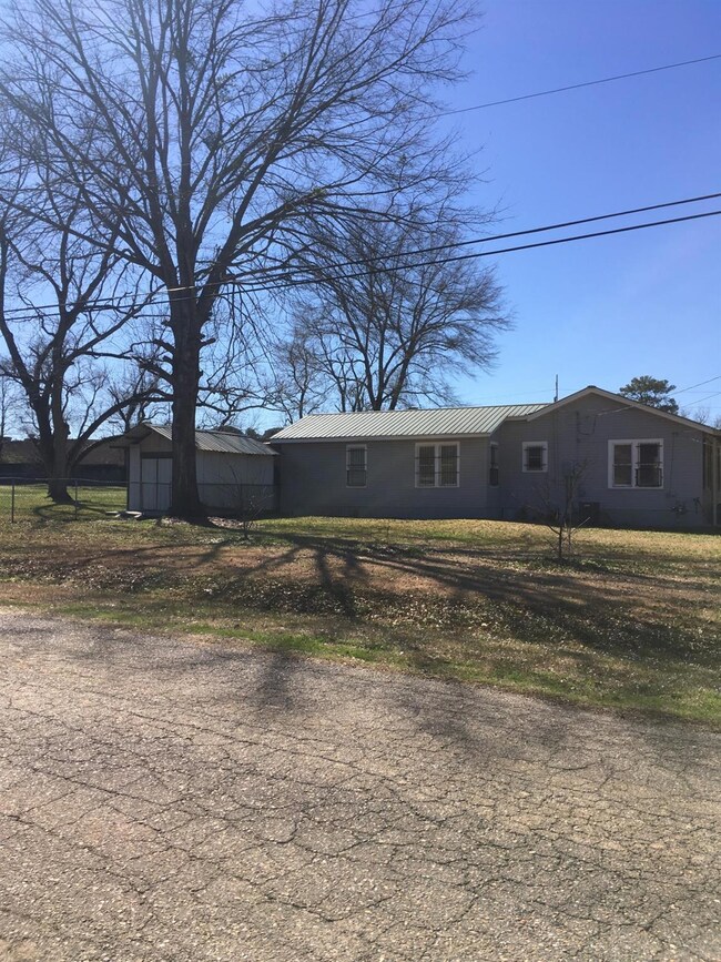 View of front of house with metal roof