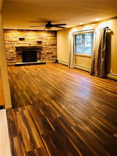 Large Living with log Fireplace, Bay Window and New Flooring