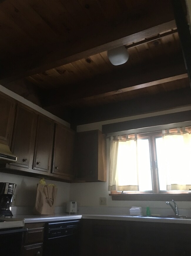 Exposed wooden beams run over the kitchen and thro