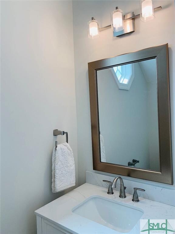 Powder room downstairs with new lighting and vanit