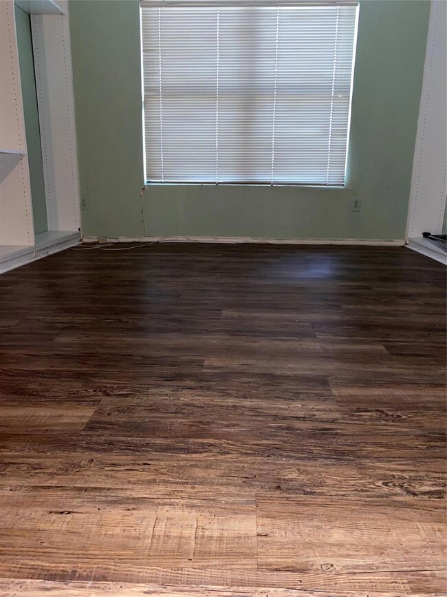 Unfurnished room featuring dark wood-style floors