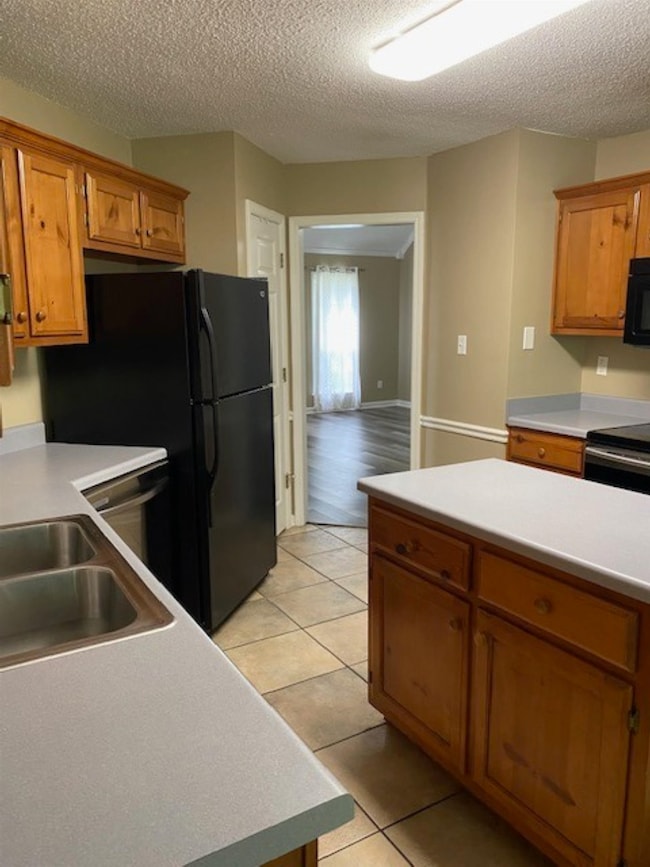 The chef in your family will say this is it! An island and soo many countertops! Black appliances and the refrigerator stays!