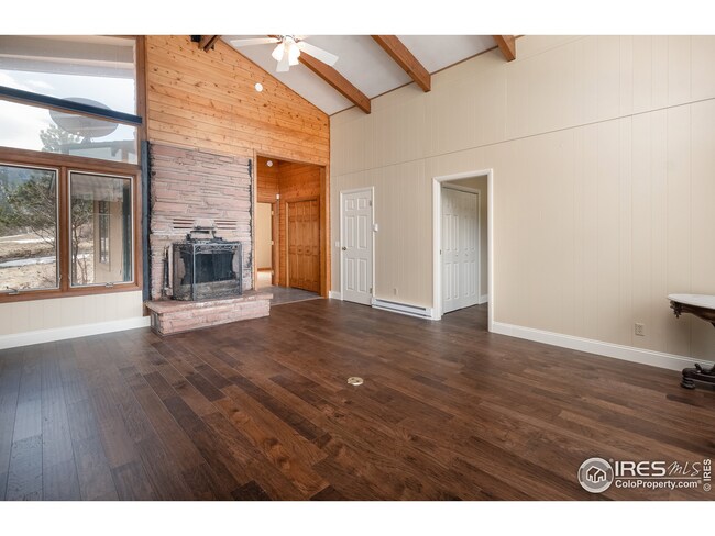 Great room with wood burning fireplace and new wood floors