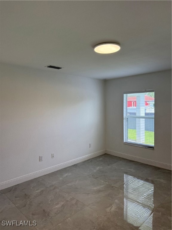 Empty room featuring baseboards