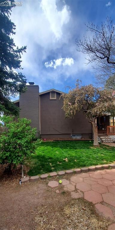 Rear view w/ grassy yard