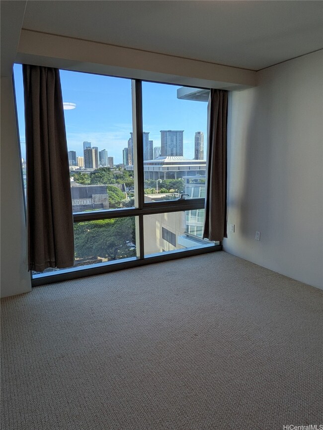 The bedroom features floor to ceiling windows and a split AC.