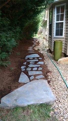 The backyard view of the stone walkway.