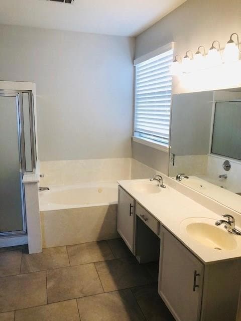 Bathroom with a bath, double vanity, a shower stall, and light tile patterned floors