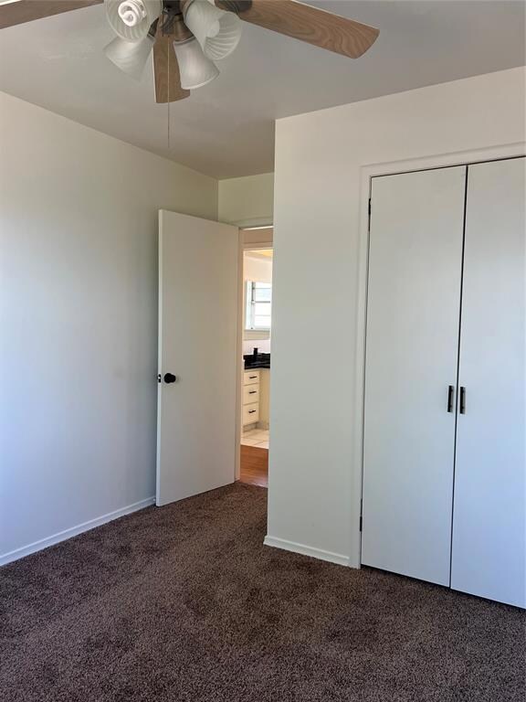 Unfurnished bedroom featuring ceiling fan, dark ca