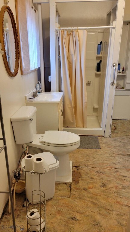 Bathroom with a shower, vanity, toilet, and wood-t