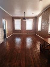 Unfurnished living room with ornamental molding and dark wood-style floors