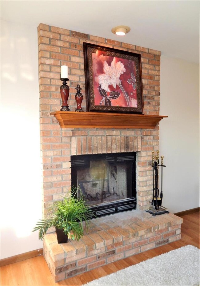 Full-brick, wood-burning fireplace w/wood mantle a