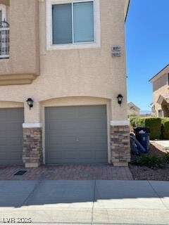 Garage featuring decorative driveway