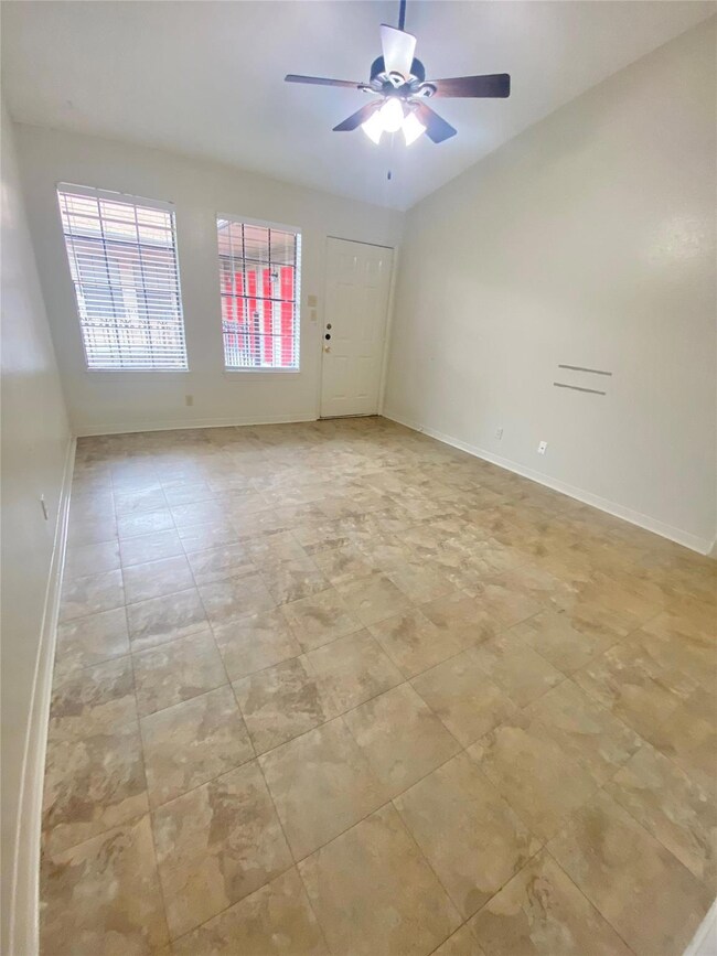 Spare room featuring ceiling fan and baseboards