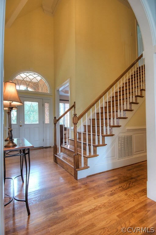 Two story foyer with hardwood floors and moldings