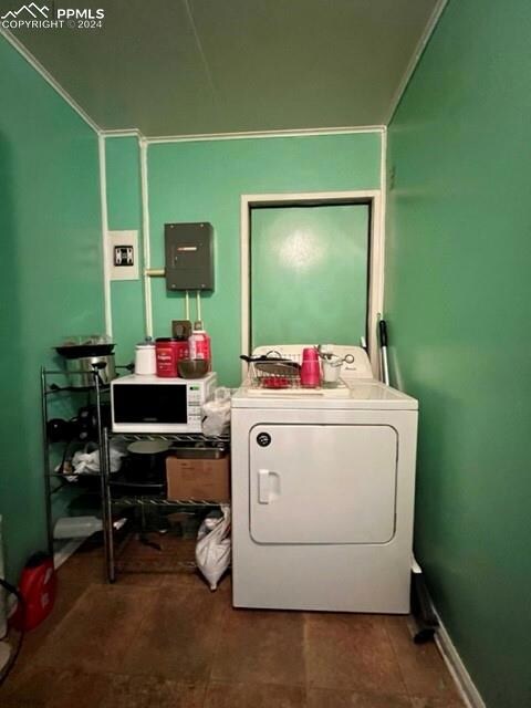 Laundry area featuring washer / dryer, dark tile f