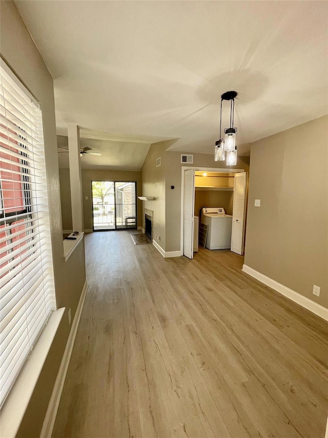 Unfurnished living room featuring light hardwood /
