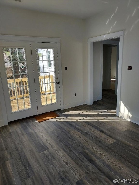 Doorway with dark wood-type flooring and a healthy