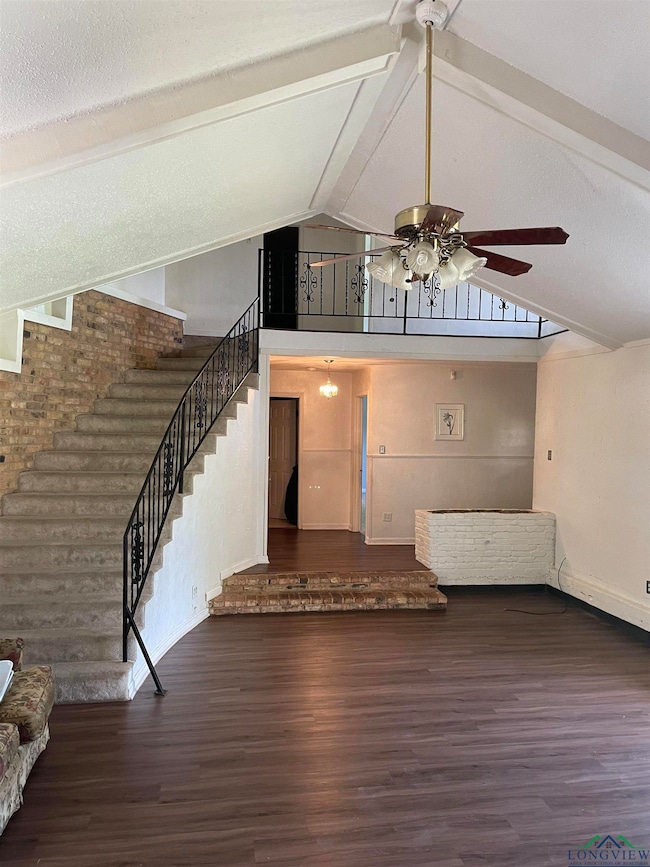 Unfurnished living room featuring dark hardwood / 