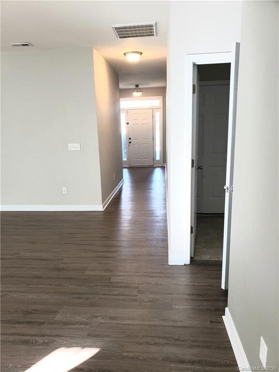 The 2 bedrooms are to the left of the entry door. Entry hall leads to the great room.