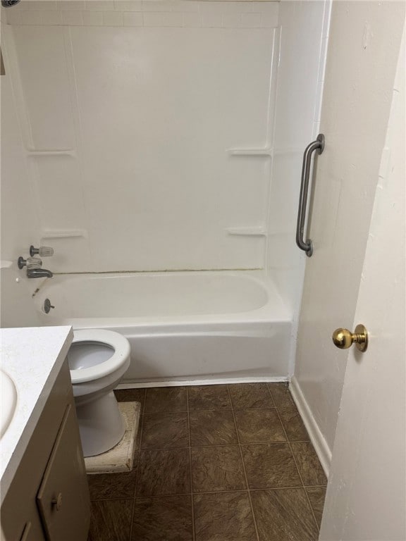Full bath with vanity, bathtub / shower combination, and dark tile patterned flooring
