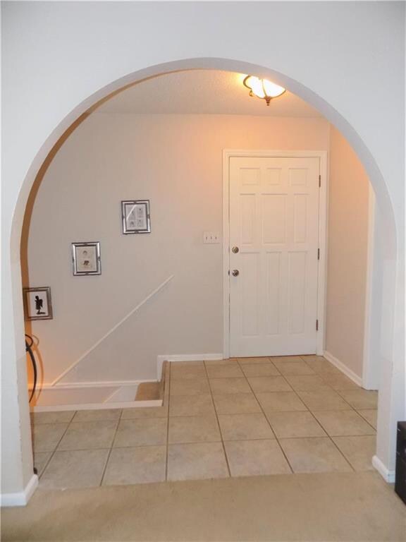 Tile entry and arched doorway to Great Rm.