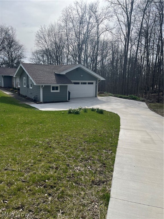 Single story home with a front lawn and a garage