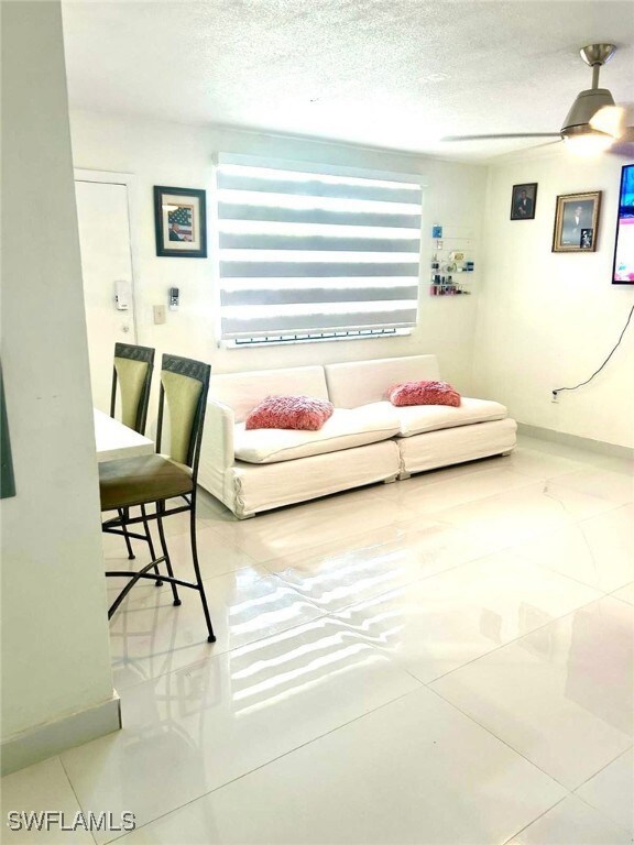 Living room with tile patterned flooring, a textur
