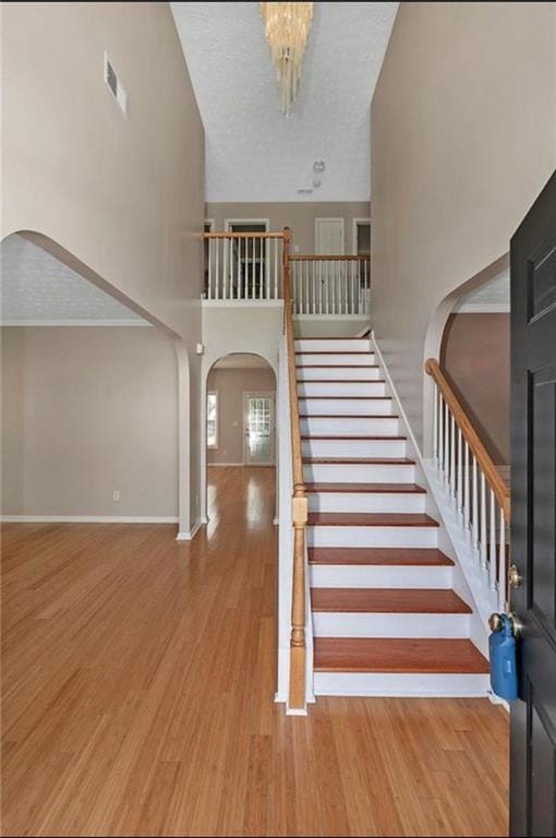 Stairs with arched walkways, wood finished floors,